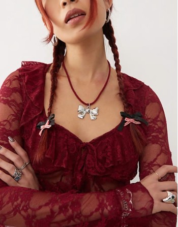 necklace with bow pendant on red cord