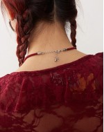 necklace with bow pendant on red cord