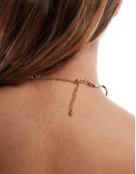 torque choker with wave design in gold tone